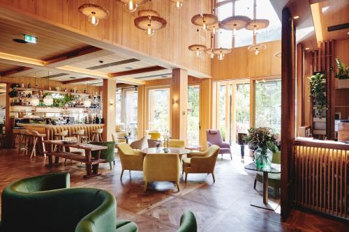 a restaurant with tables and chairs and a bar at MalisGarten Green Spa Hotel - Adults Only in Zell am Ziller