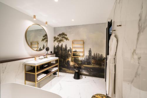bagno con lavandino e specchio di Aigle Noir Fontainebleau MGallery a Fontainebleau