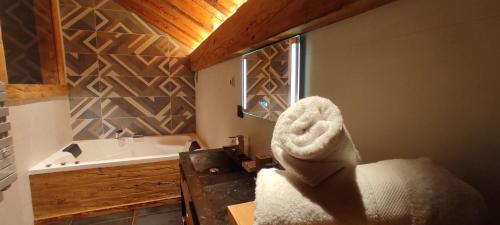 a bathroom with a bath tub and a sink at Esprit de la Meije - Chalet overlooking the Meije in La Grave