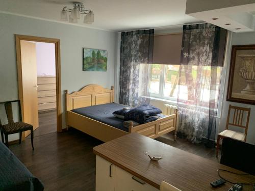 a small bedroom with a bed and a window at Aardla - Nice 2-bedroom Apartment - Rahu street - 3 big beds in Tartu