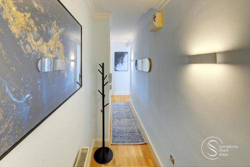a hallway with a large painting on the wall at Leamington Spa Warwick Place Apartments in Leamington Spa