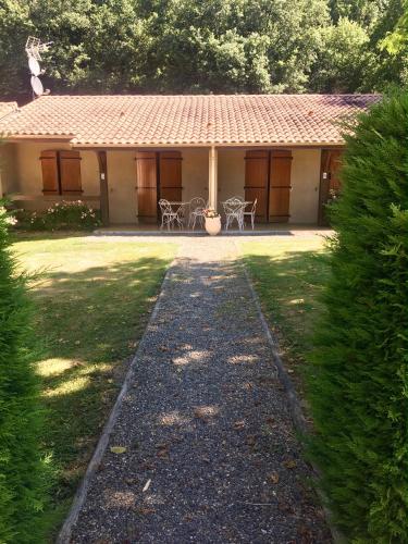 a house with a pathway in front of it at bungalows les thuyas in Eugénie-les-Bains