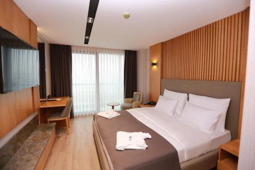 Ένα ή περισσότερα κρεβάτια σε δωμάτιο στο Pikola Otel