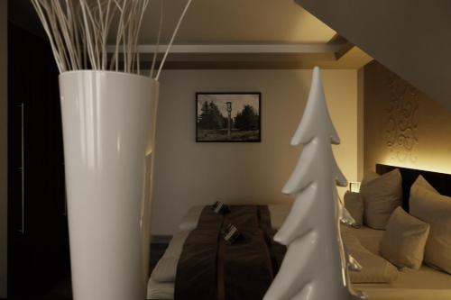 a room with a couch and two christmas trees at Villa Silva - Oberhof in Oberhof
