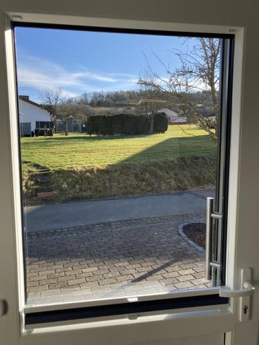 a view of a field through a window at Ferienwohnung Zum Eifelelch in Daun