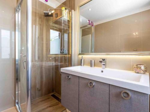 La salle de bains est pourvue d'un lavabo et d'une douche. dans l'établissement Srok Apartments with pool, à Kastav