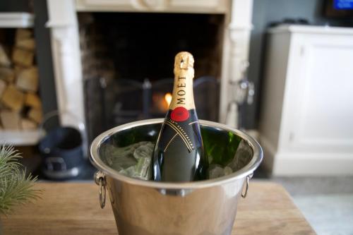 a bottle of wine in a bucket on a counter at Stunning 5 Bedroom Victorian home with optional hot tub in Pershore