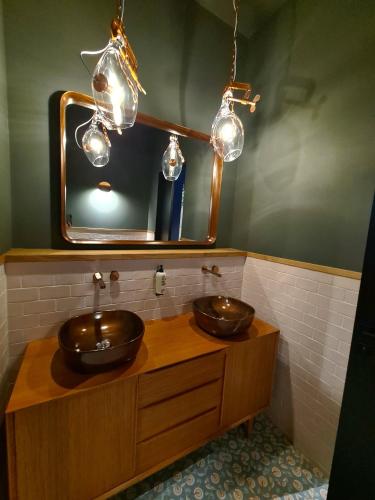 a bathroom with two sinks and a mirror at KONCEPT HOTEL International in Cologne