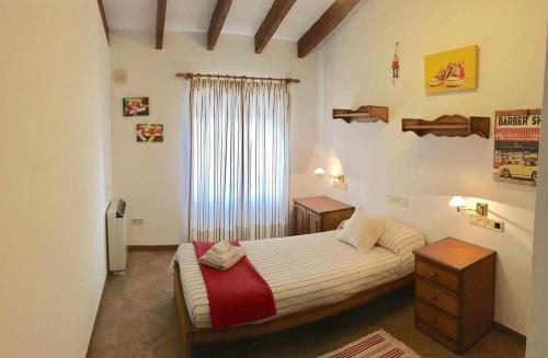 a bedroom with a bed and two tables and a window at Family Home Jaume II Casa Familiar Jaume II in Llucmajor