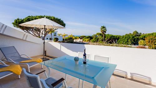 a blue table and chairs on a balcony at Quinta do Lago Country Club in Quinta do Lago