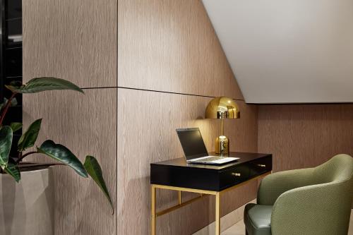 a room with a desk with a laptop on it at Crowne Plaza Sydney Darling Harbour by IHG in Sydney