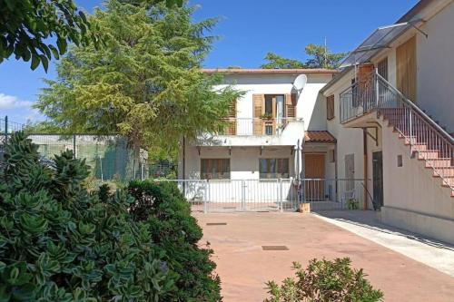 una casa bianca con una scala davanti di Casa Olea a Montarice