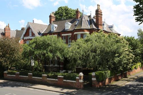 a large brick house with a gambrel roof at Ascot House in York