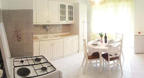 a kitchen with a table and a stove top oven at Apartment Mirjana in Fažana
