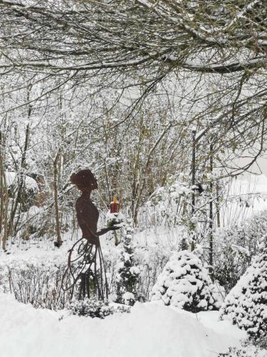 a statue of a bird on a bike in the snow at Hotel Pension Wolf in Ebermannstadt
