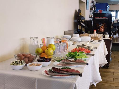 a long table with plates of food on it at Dolna Bania Hotel in Dolna Banya