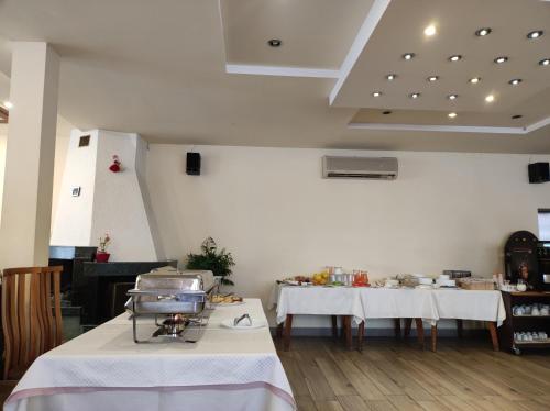 a room with two tables with white table cloth at Dolna Bania Hotel in Dolna Banya