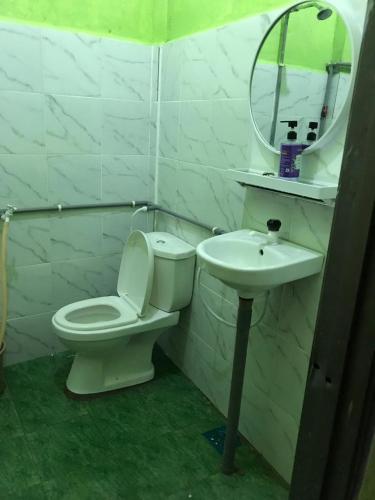 a bathroom with a toilet and a sink at Perhentian Hazipah in Perhentian Island