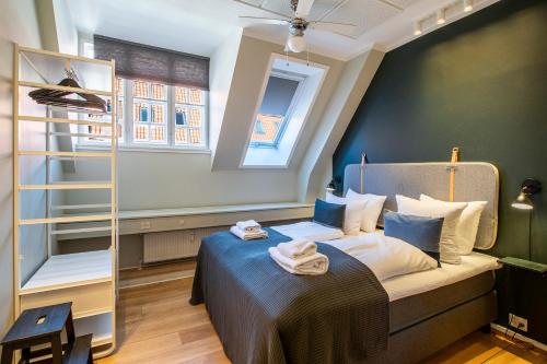 a bedroom with a bed with blue walls and a ladder at Kings Garden 1 by Daniel&jacob's in Copenhagen