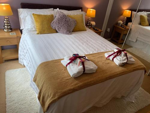 a bedroom with a large bed with towels on it at Headland View. Luxury. Harbour-Front. With Parking in Falmouth