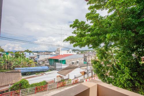 a view of a city from the balcony of a building at Tree Home ที่พักเบตงสไตล์ครอบครัว in Ban Komo Sip Paet