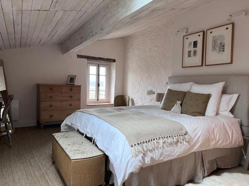 a bedroom with a large bed and a window at Maison Père in Lagarde