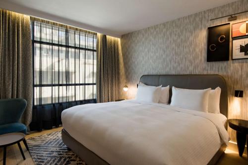 a hotel room with a large bed and a large window at Radisson Blu Hotel Casablanca City Center in Casablanca