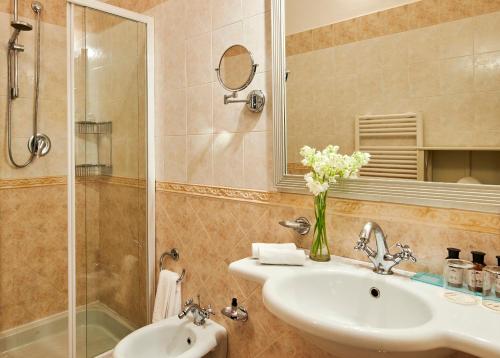 a bathroom with a sink and a shower at Bagni Di Pisa Palace & Thermal Spa - The Leading Hotels of the World in San Giuliano Terme