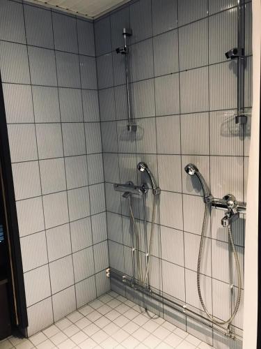 a bathroom with two shower heads in a stall at Ski Center Alpine Houses A4 in Levi
