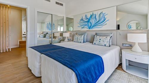 a bedroom with a large bed with a blue blanket at Quinta do Lago Country Club in Quinta do Lago