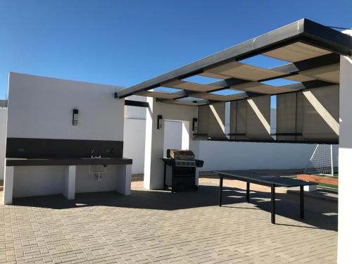 a pavilion with a picnic table and a bench at DOLPHIN Maeva Residencial in Puerto Peñasco