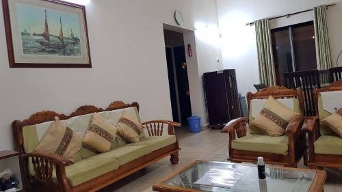 a living room with two couches and a coffee table at Redstone Hills, Diveagar in Diveagar