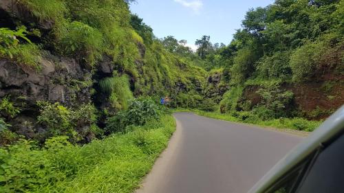 a car driving down a road on a mountain at Redstone Hills, Diveagar in Diveagar