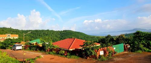 a group of houses with a car parked in front at Redstone Hills, Diveagar in Diveagar