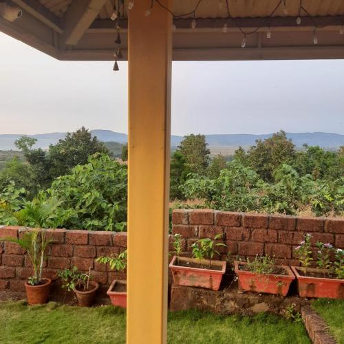 a brick wall with a bunch of plants at Redstone Hills, Diveagar in Diveagar