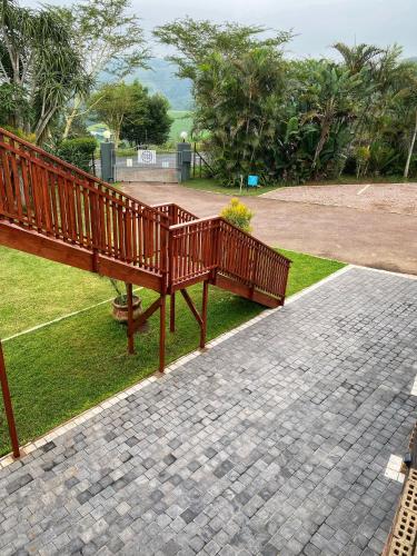 a wooden bench sitting on top of a brick walkway at Fever Tree Guesthouse in Hillcrest