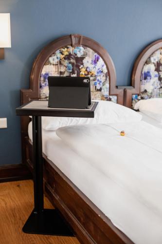 a laptop computer sitting on top of a bed at Altstadt Hotel Stadtkrug in Salzburg