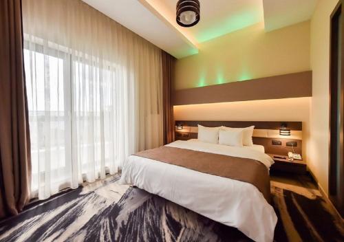 Ένα ή περισσότερα κρεβάτια σε δωμάτιο στο Hotel Scapino