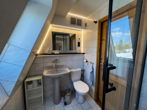 a small bathroom with a toilet and a sink at Guest House Privát Štrba in Štrba