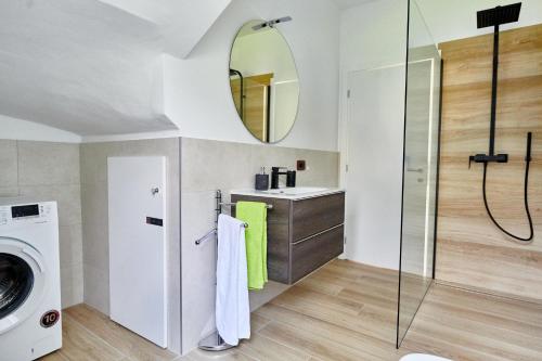 a bathroom with a sink and a washing machine at Casa Titi in Malcesine
