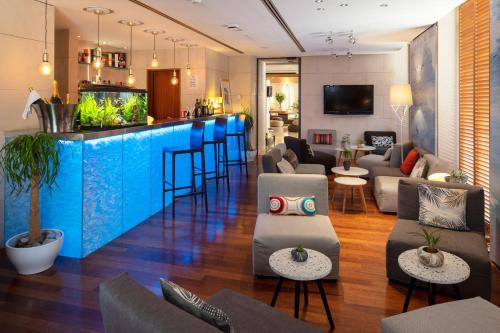 a lobby with a bar and a fish tank at Hotel Beau Rivage in Nice