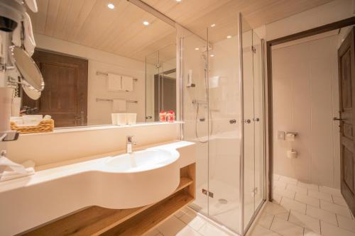 a bathroom with a sink and a shower at Altstadt Hotel Stadtkrug in Salzburg