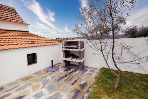 a building with a piano next to a tree at Pomar das Oliveiras - Private Swimming pool - Free EV Chrg - Pet Friendly in Carvalhal Cimeiro