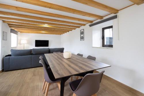 a dining room with a table and a couch at Pomar das Oliveiras - Private Swimming pool - Free EV Chrg - Pet Friendly in Carvalhal Cimeiro