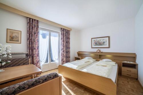 a hotel room with a bed and a window at Residence Pichler Apartment 2 in San Leonardo in Passiria