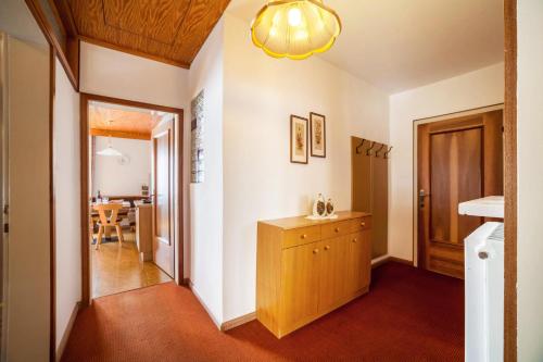 a hallway with a wooden cabinet and a dining room at Residence Pichler Apartment 1 in San Leonardo in Passiria