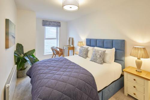 a bedroom with a large bed and a window at Host & Stay - 3 Queens Court in Whitley Bay