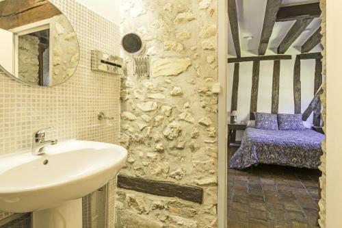 uma casa de banho com um lavatório e um espelho em Moulin de Flagy 