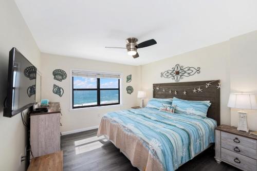 a bedroom with a bed and a flat screen tv at Sunswept 607 condo in Orange Beach