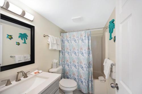 a bathroom with a sink and a toilet and a shower at Sunswept 607 condo in Orange Beach
